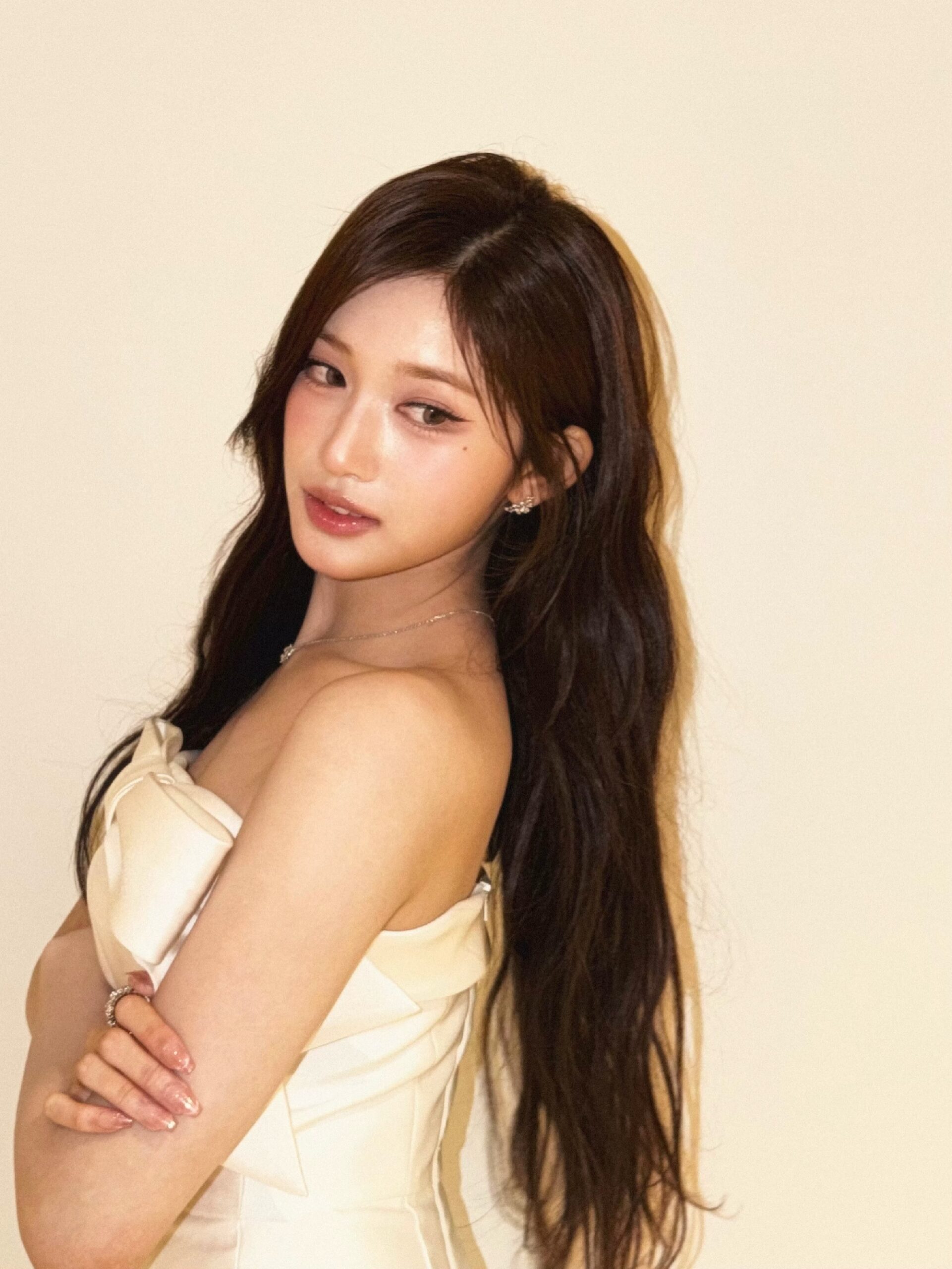 Lee Seo Teasing Thighs While Sitting Crouched in the Hallway Wearing a White Mini Dress