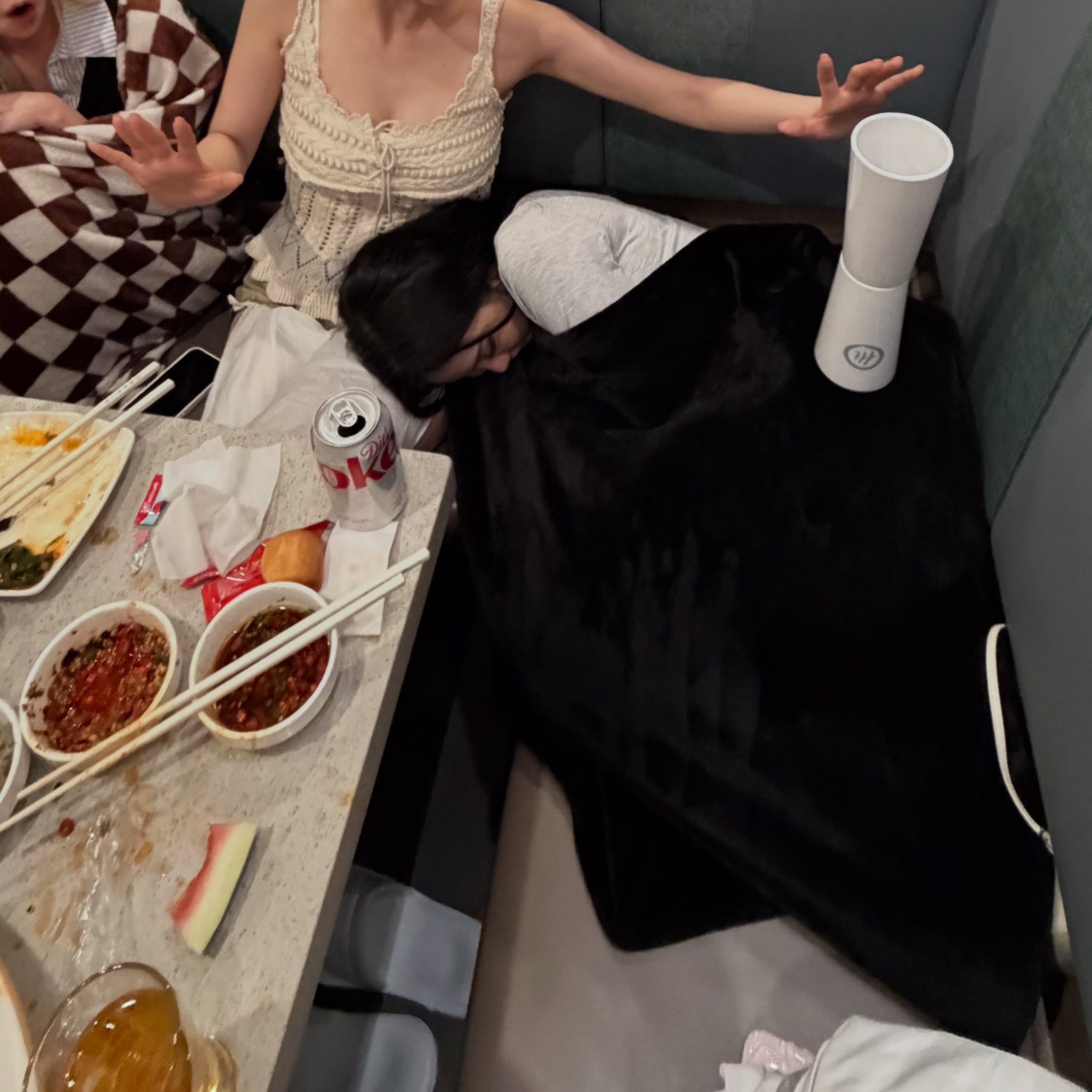 Karina placing a tumbler on Ningning while she sleeps
