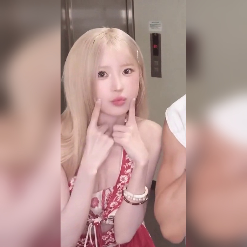 Song Hayoung showing off her cute aegyo in a red Hawaiian sleeveless outfit with exposed cleavage