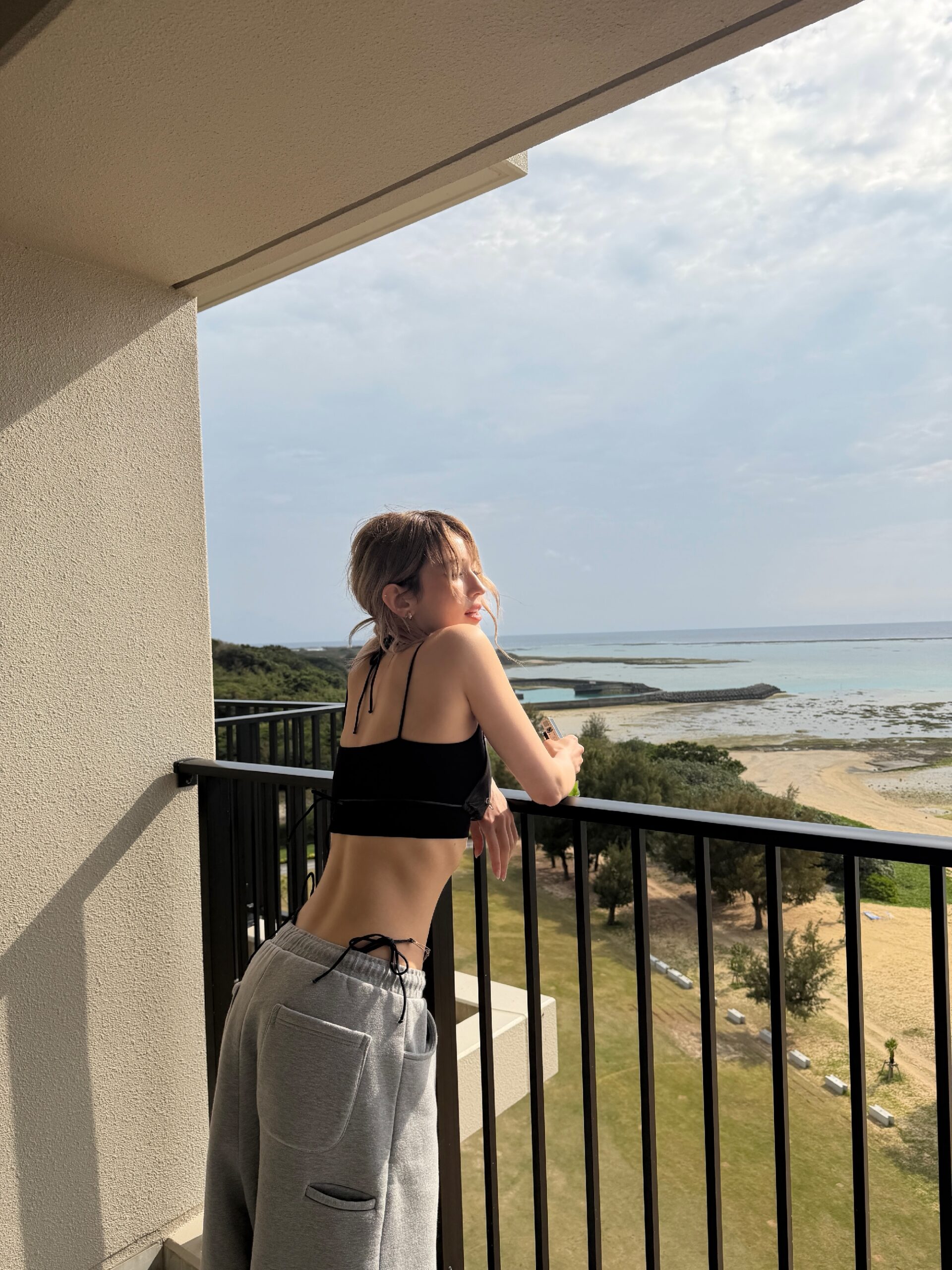 Jeon Somi’s legendary honey abs with a sexy belly button, wearing a black-string bikini over her outfit