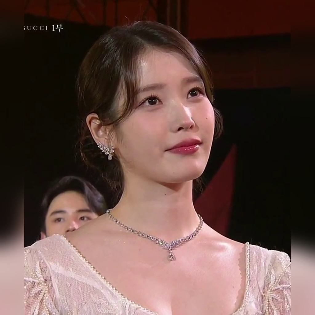 IU at the 61st Baeksang Arts Awards in a white dress with fluffy cleavage exposure